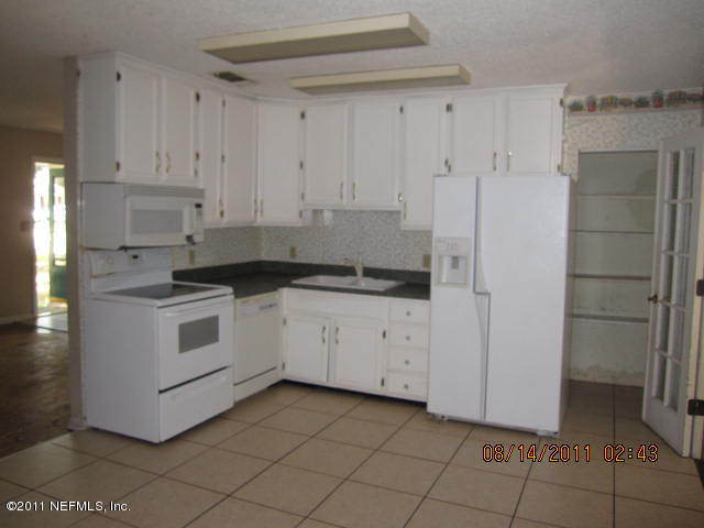 1360 Prince Road St. Augustine, FL 32086 - Photo 2 of 8 a white kitchen with a sink and cabinets