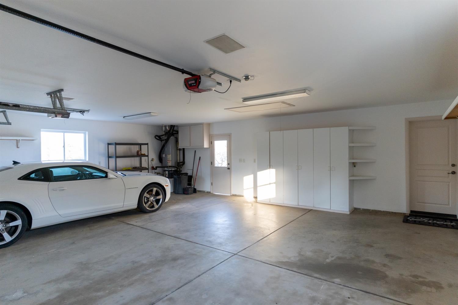 28067 Circle J Ranch Road O'Neals, CA 93645 - Photo 38 of 45 Finished 3 car garage with cabinets.