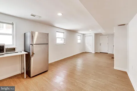 a kitchen with stainless steel appliances a stove a microwave and a sink