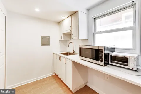 a kitchen with a refrigerator sink and cabinets