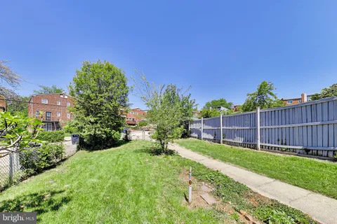 a view of a building with a garden and pathway