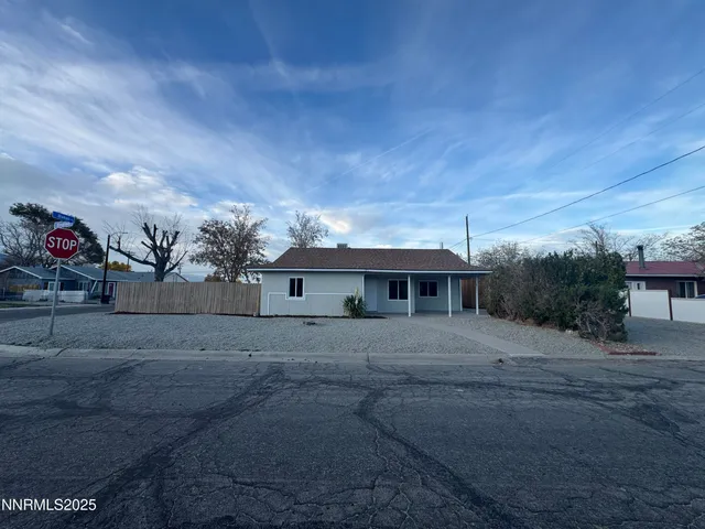 a front view of house with yard and trees