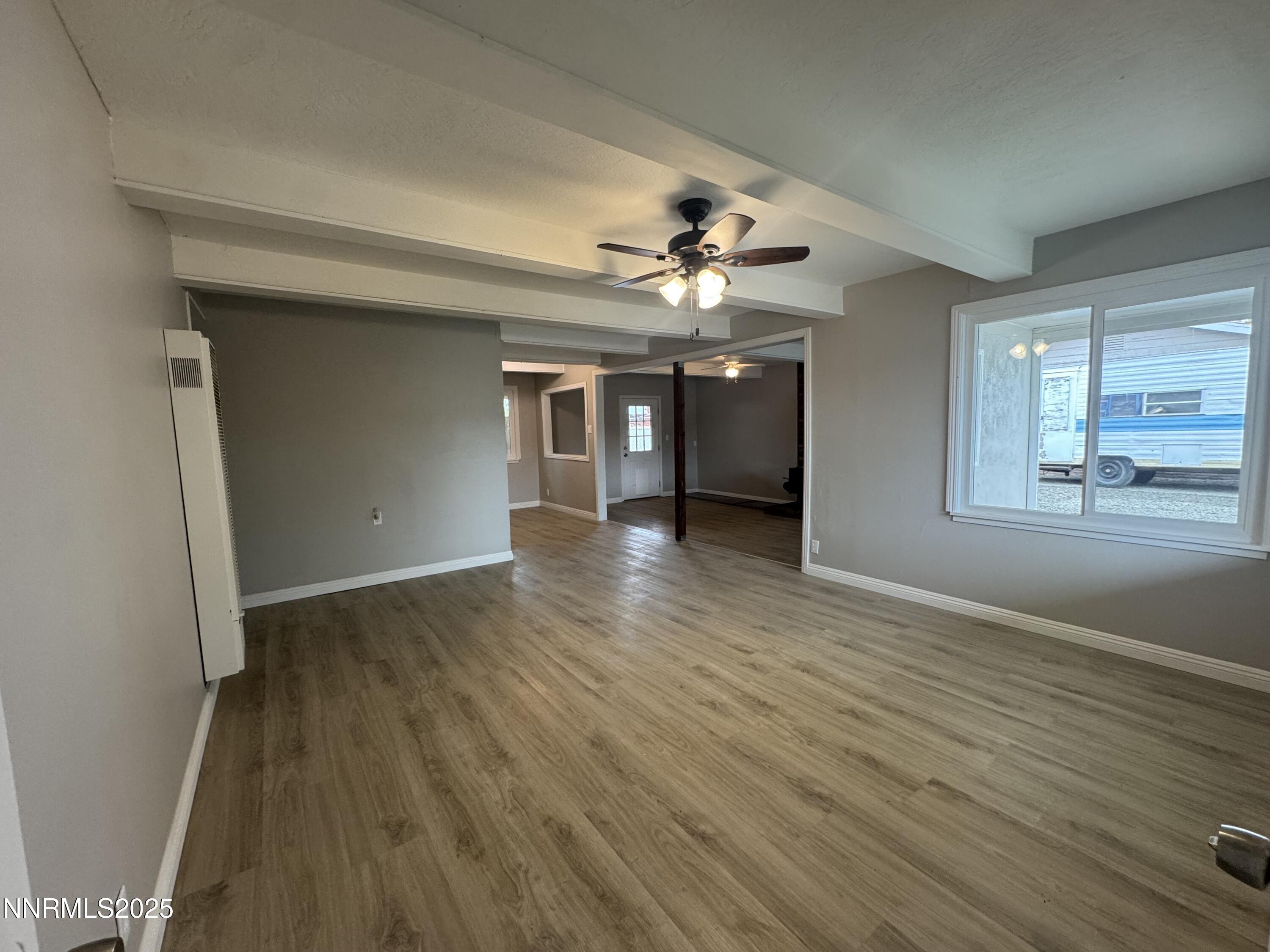 125 English Street Hawthorne, NV 89415 - Photo 7 of 16 wooden floor in an empty room with a window