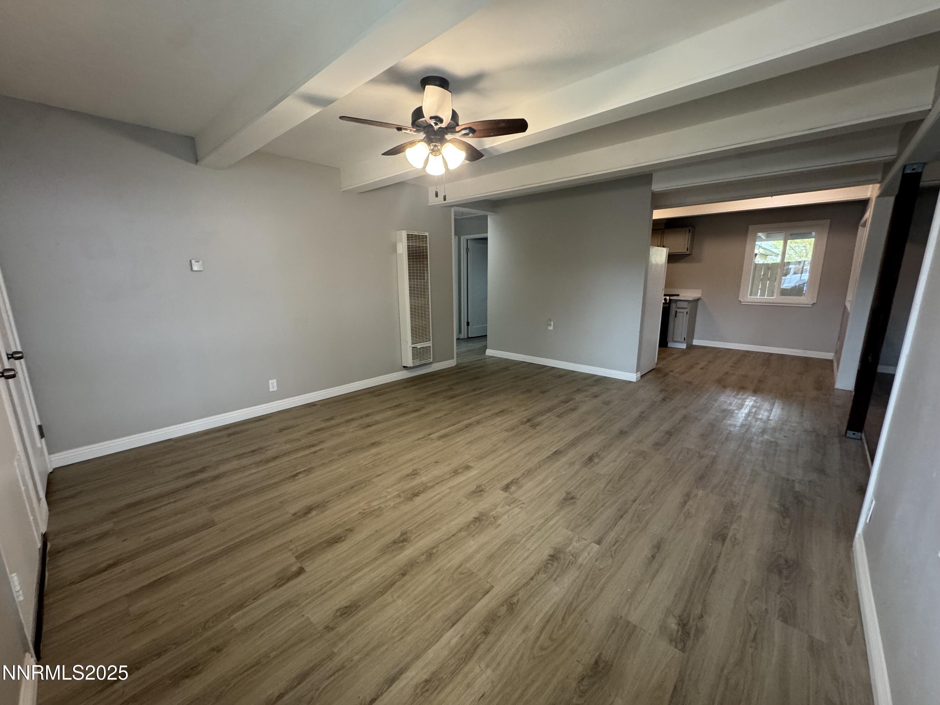 125 English Street Hawthorne, NV 89415 - Photo 8 of 16 a view of an empty room with wooden floor and a ceiling fan