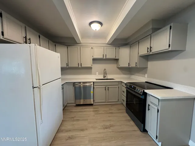 a kitchen with a refrigerator a sink and dishwasher
