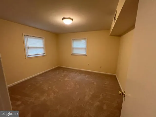 an empty room with a empty space and windows