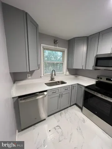 a kitchen with a refrigerator stove and sink