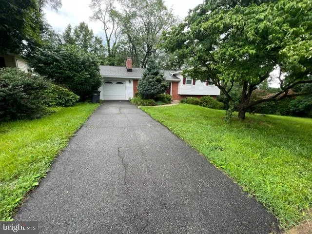 a front view of a house with a yard and a garage