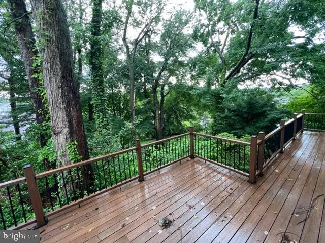 a view of balcony with wooden floor and fence