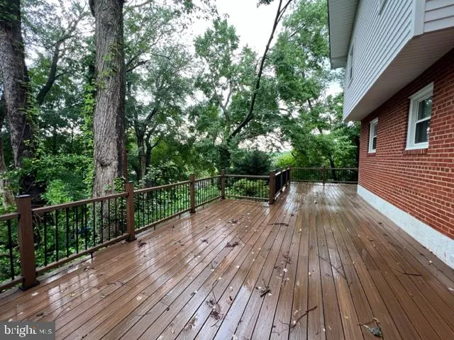 a view of deck with seating space and trees