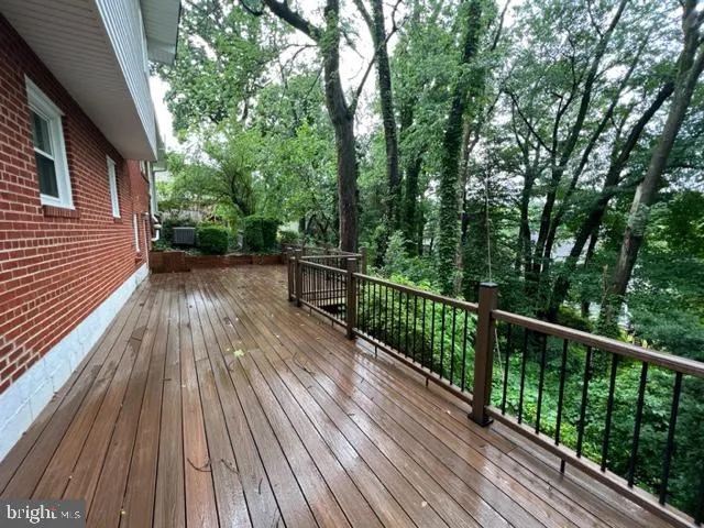 a view of balcony with wooden floor and fence