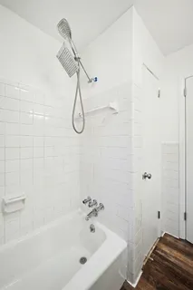 a spacious bathroom with a double vanity sink a mirror and a shower