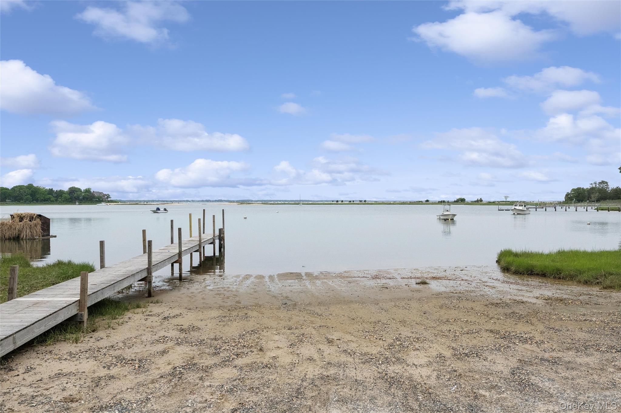 131 Red Creek Road Hampton Bays, NY 11946 - Photo 26 of 35 a view of a lake with houses in the back