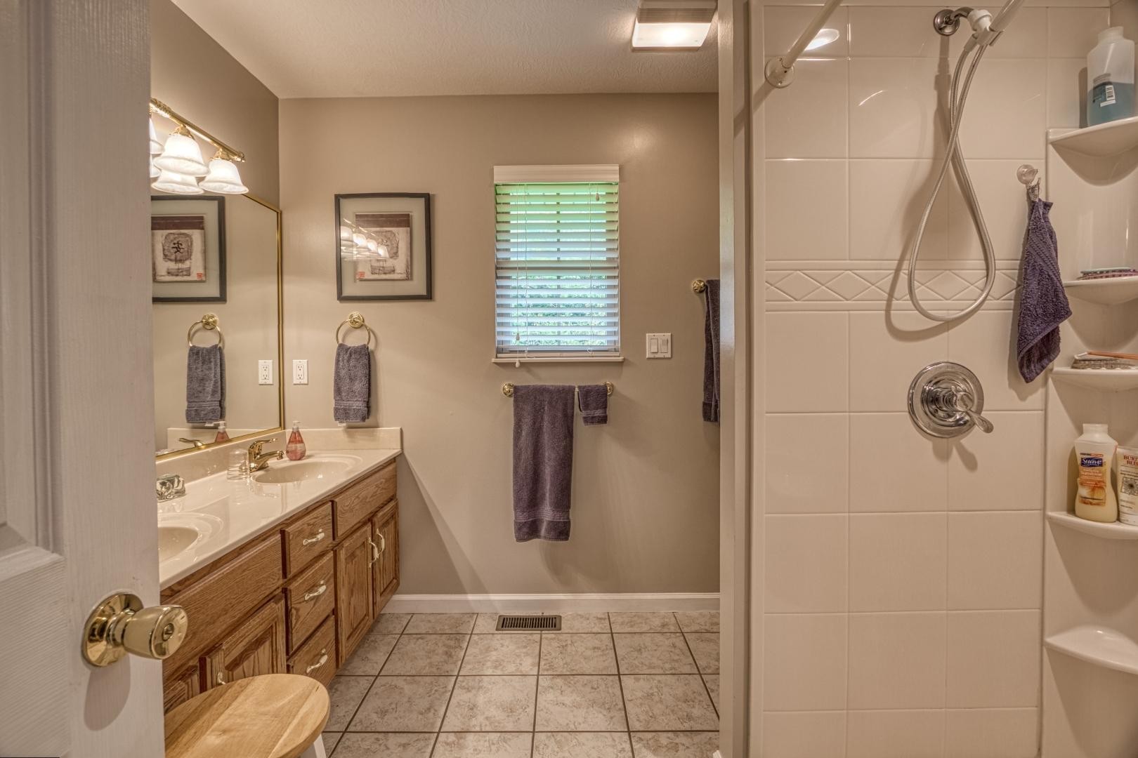 720 Rock House Road Kodak, TN 37764 - Photo 14 of 18 a bathroom with a sink and mirror