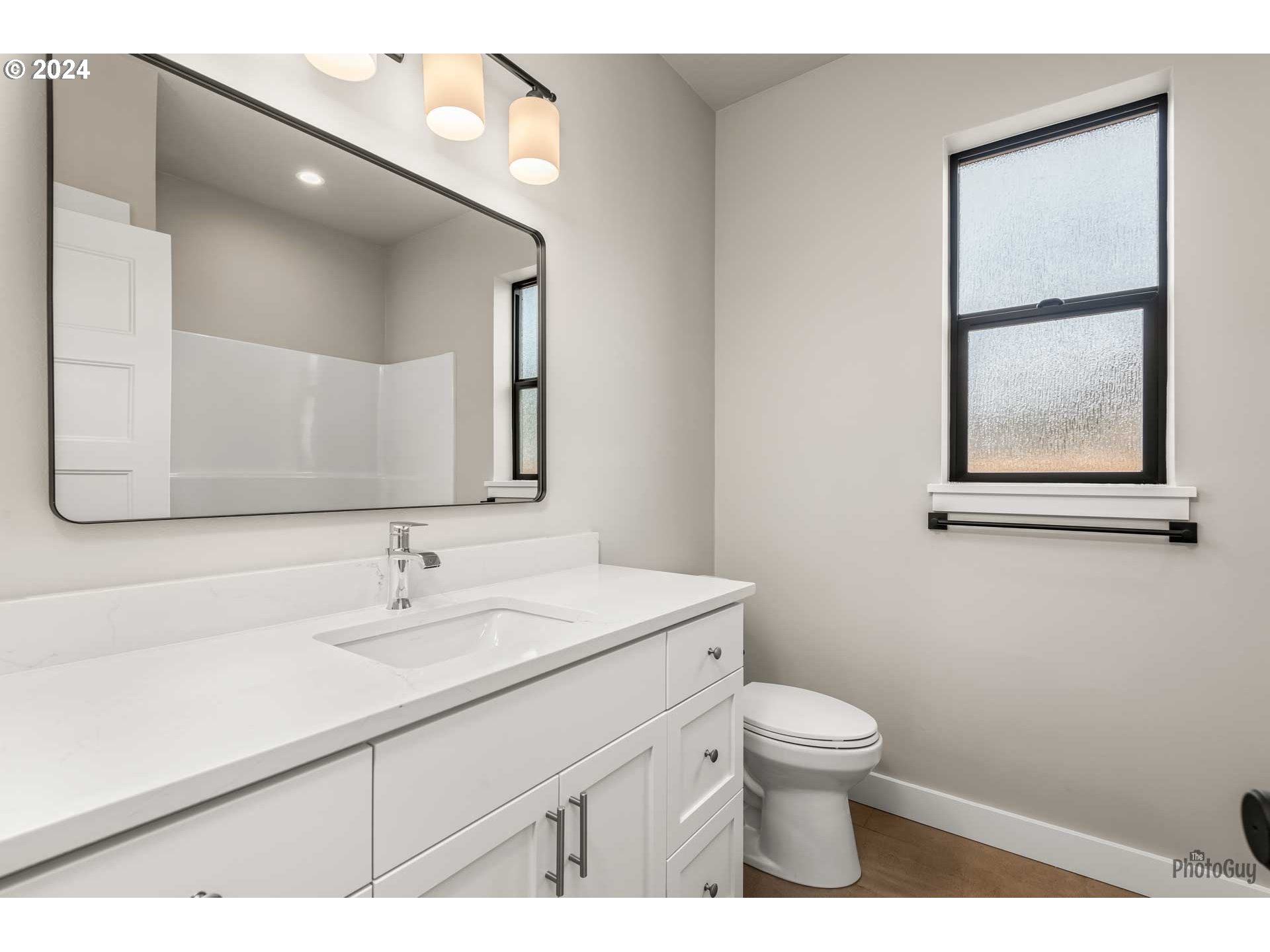 1003 South 33rd Street Springfield, OR 97478 - Photo 34 of 41 a bathroom with a toilet sink and mirror