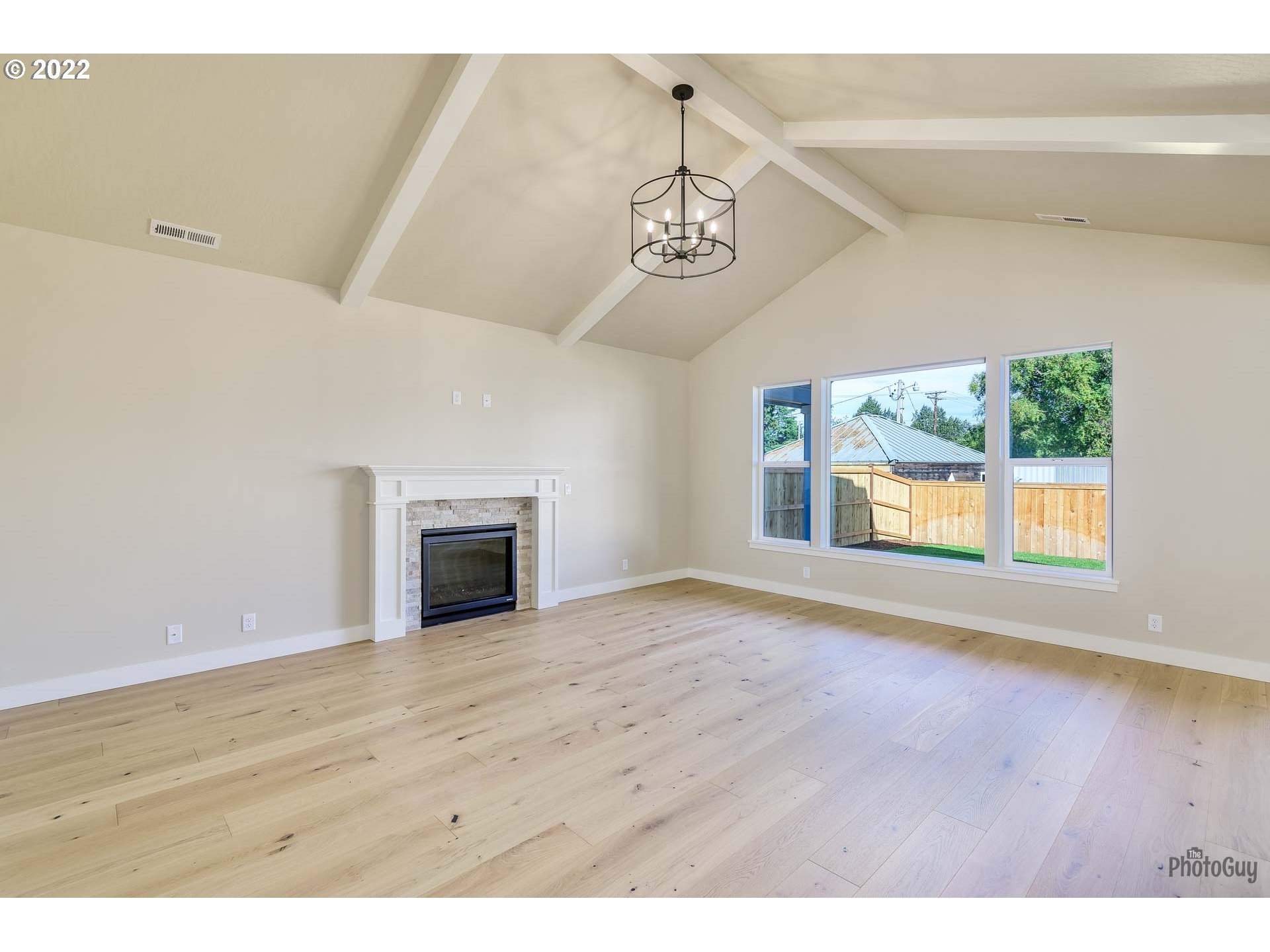 1003 South 33rd Street Springfield, OR 97478 - Photo 10 of 41 a view of a livingroom with a fireplace wooden floor and windows