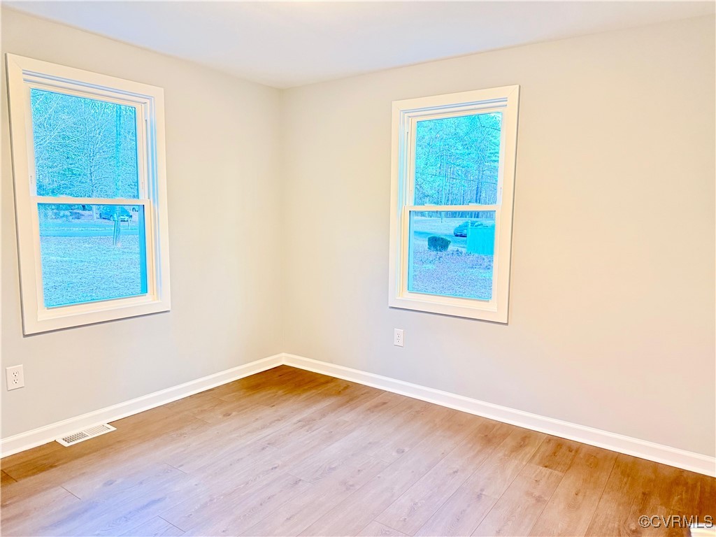 12410 Baltimore Road Ford, VA 23850 - Photo 11 of 11 a view of an empty room with wooden floor and a window