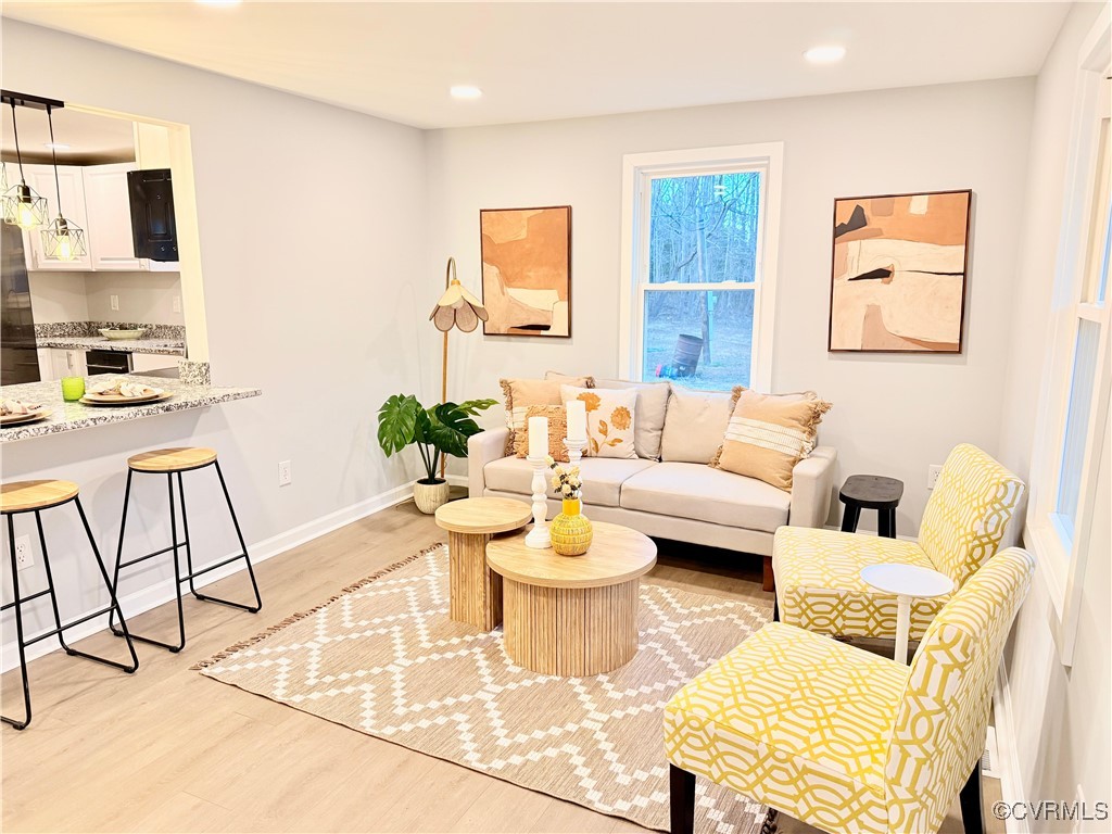 12410 Baltimore Road Ford, VA 23850 - Photo 2 of 11 a living room with furniture and a dining table with garden view