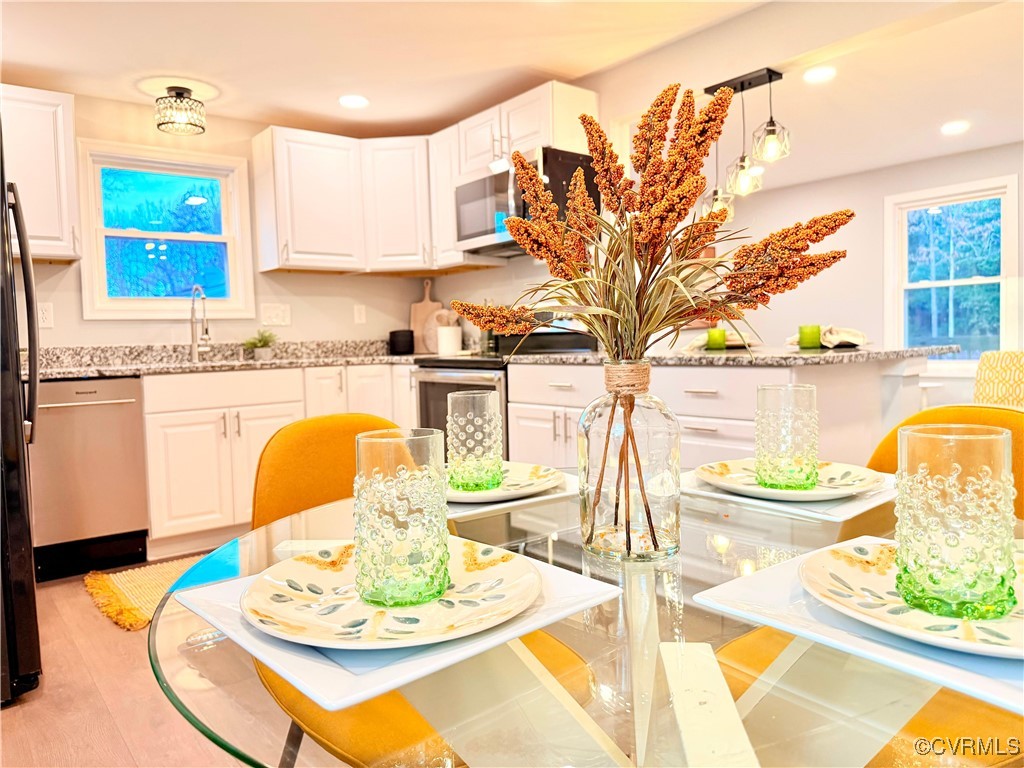 12410 Baltimore Road Ford, VA 23850 - Photo 5 of 11 a dining table with a fireplace and wooden floor