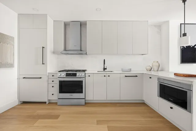 a kitchen with a stove a sink and a refrigerator