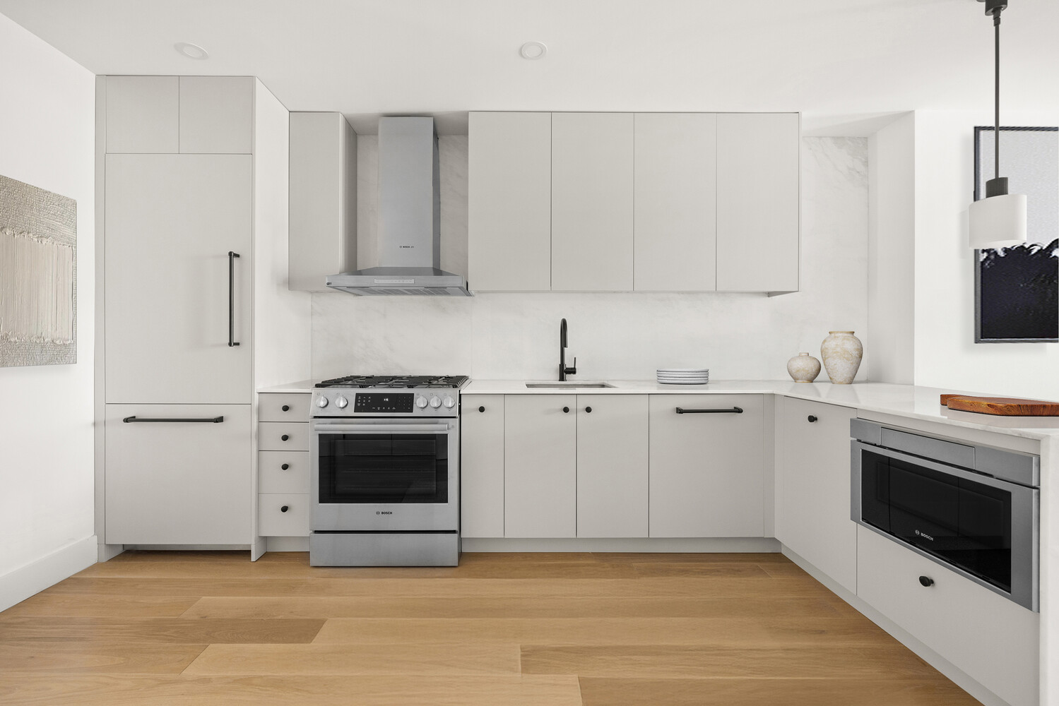 696 Chauncey Street, Unit 1R Brooklyn, NY 11207 - Photo 4 of 13 a view of a kitchen with white cabinets and stainless steel appliances