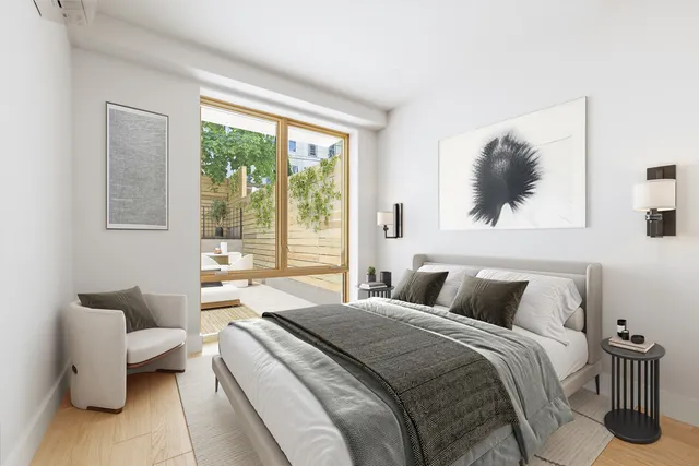 a view of a kitchen with white cabinets and stainless steel appliances