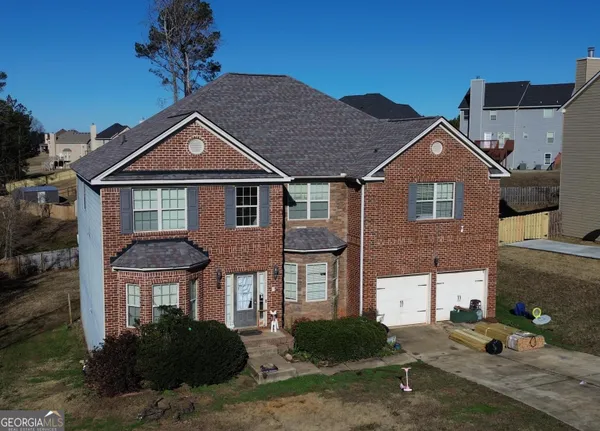 a front view of a house with a yard
