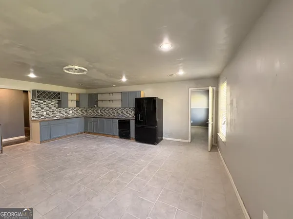 a view of a room with wooden floor