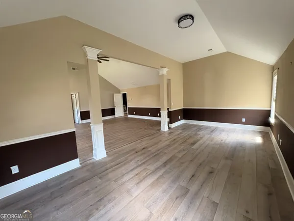 a spacious bathroom with a toilet sink mirror and bathtub