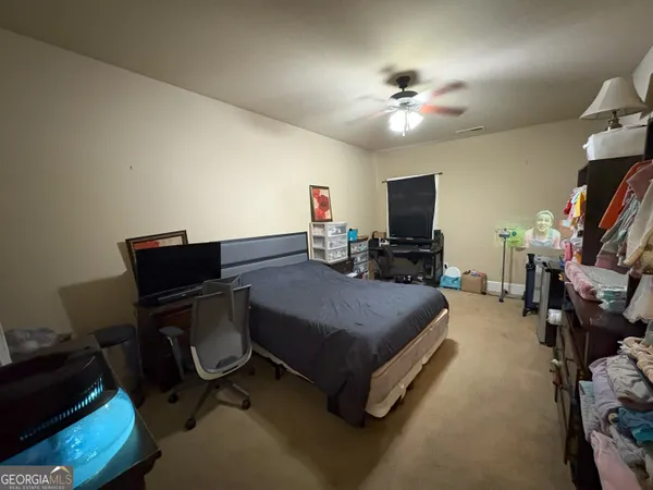 a bedroom with a bed and a desk