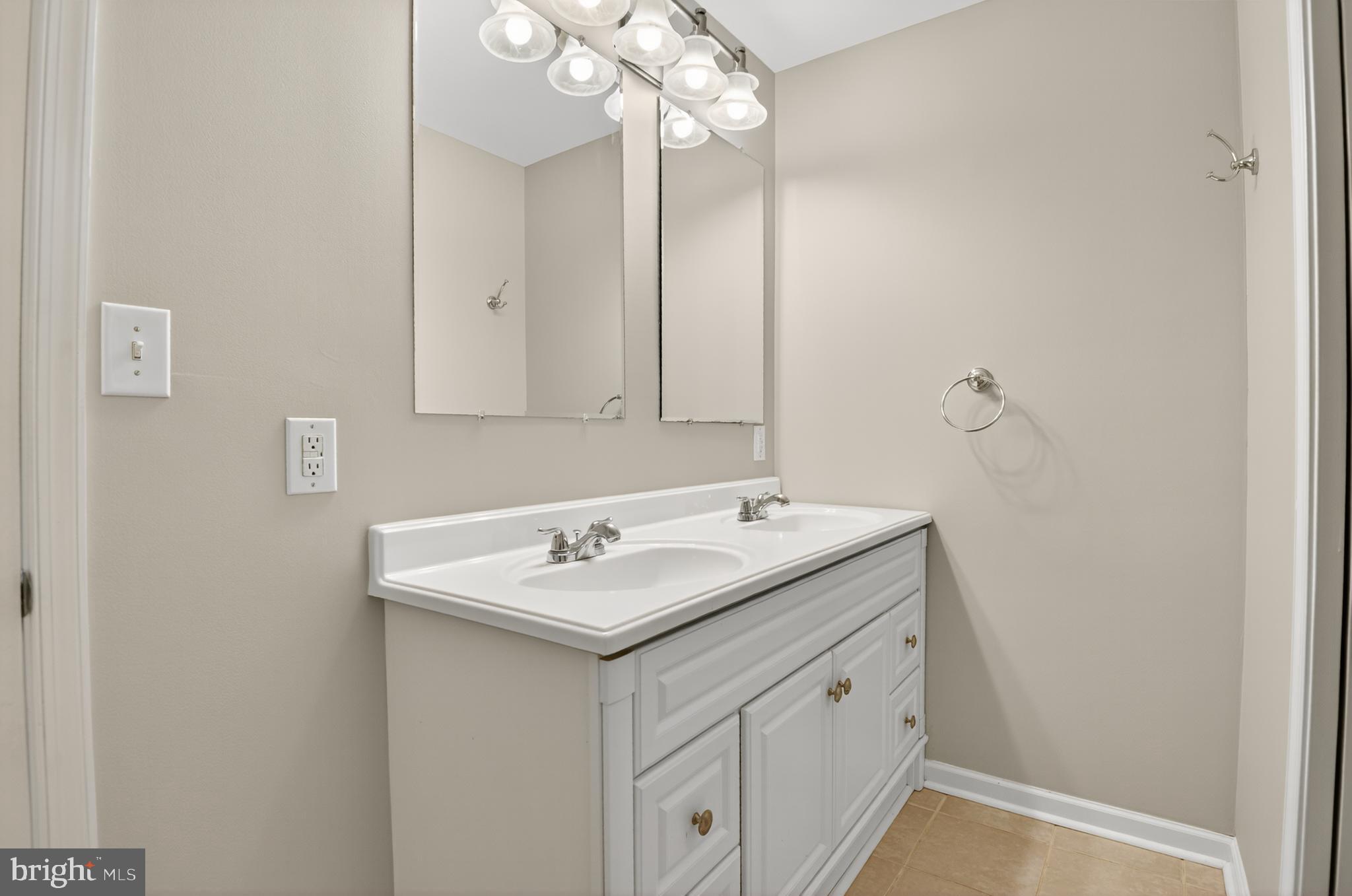 5 Turnham Court Gaithersburg, MD 20878 - Photo 19 of 56 a bathroom with a sink a light fixture and a mirror