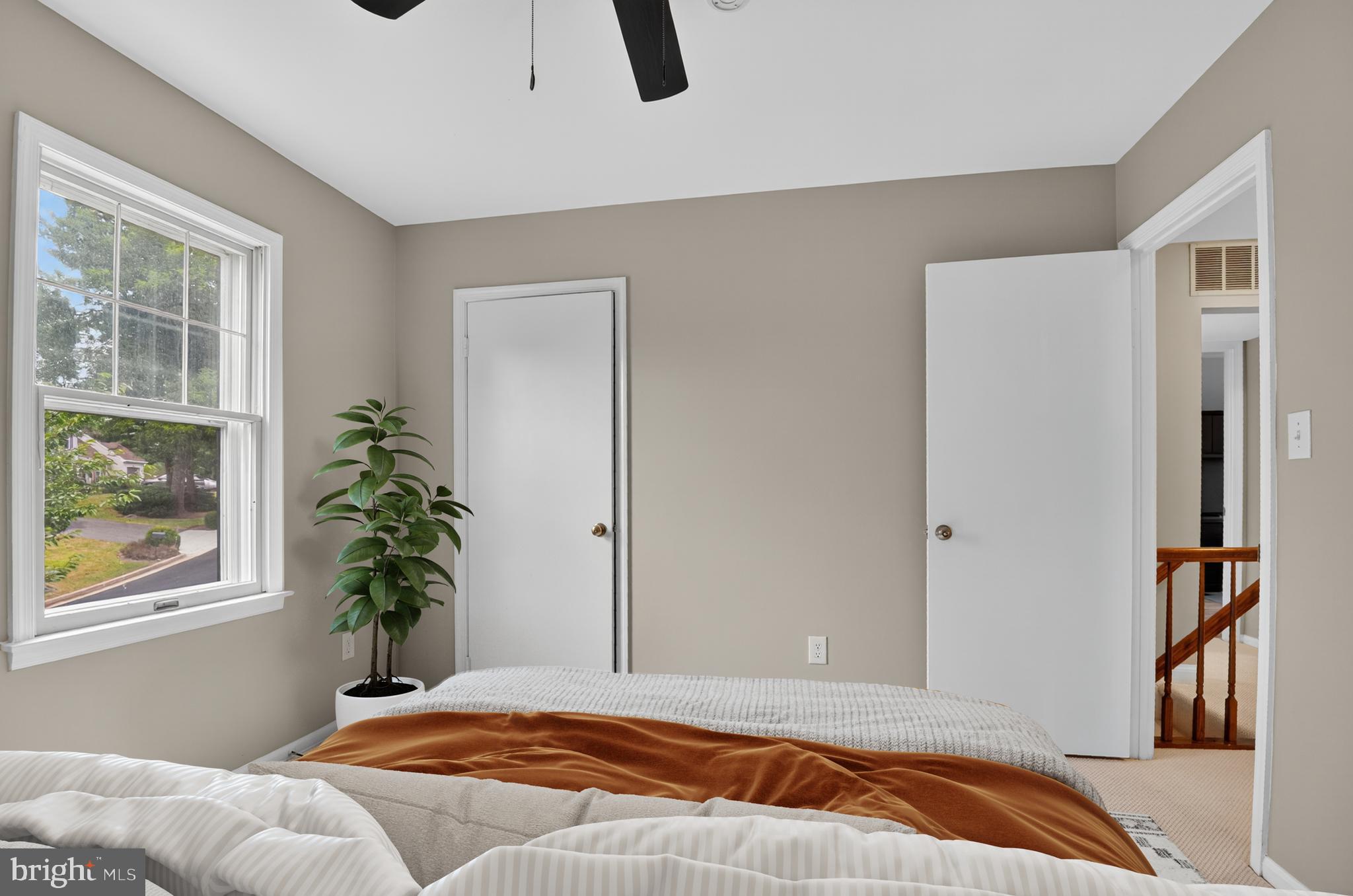 5 Turnham Court Gaithersburg, MD 20878 - Photo 24 of 56 a bedroom with a bed and a potted plant next to a window
