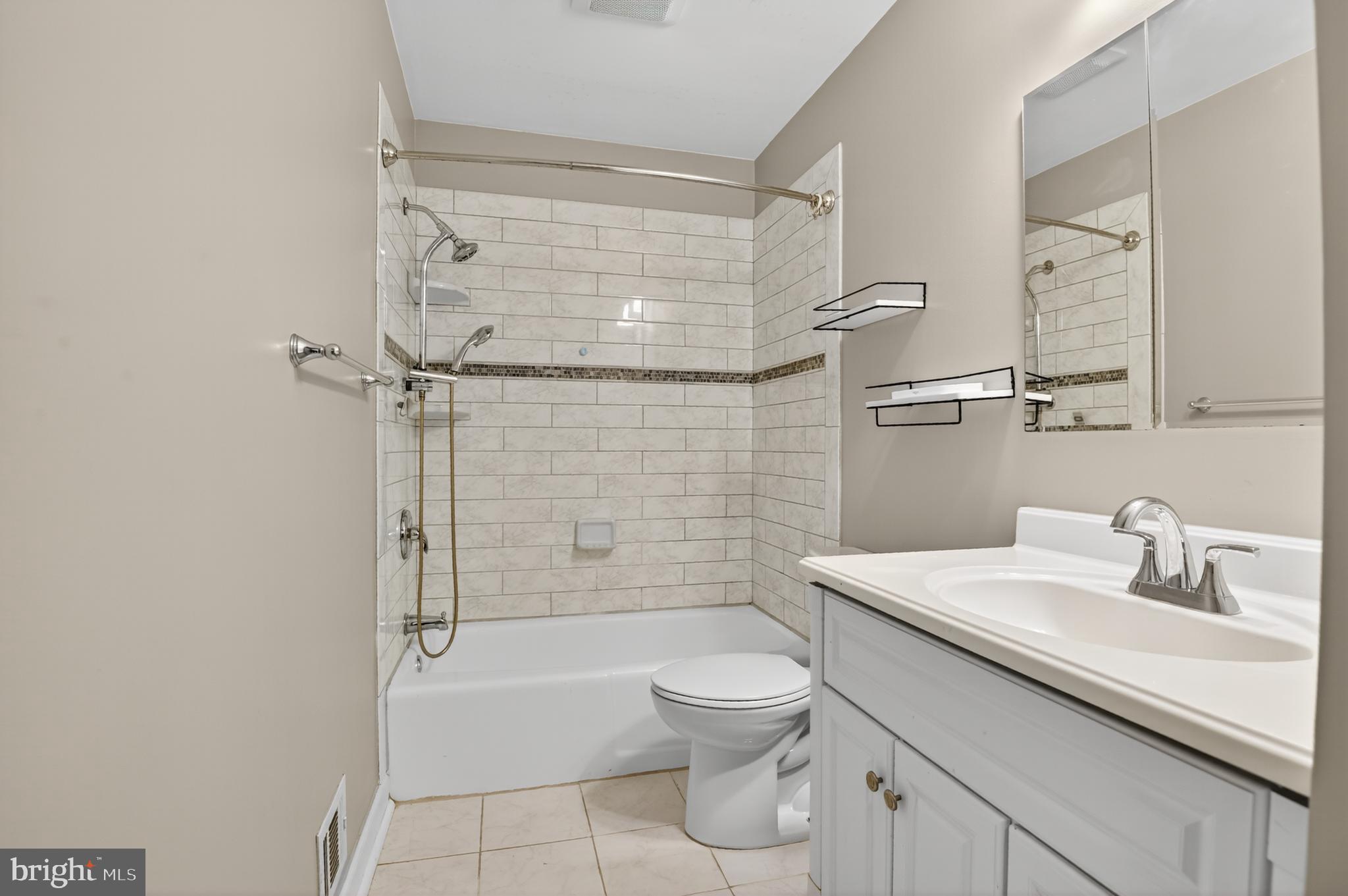 5 Turnham Court Gaithersburg, MD 20878 - Photo 27 of 56 a bathroom with a sink a toilet and shower