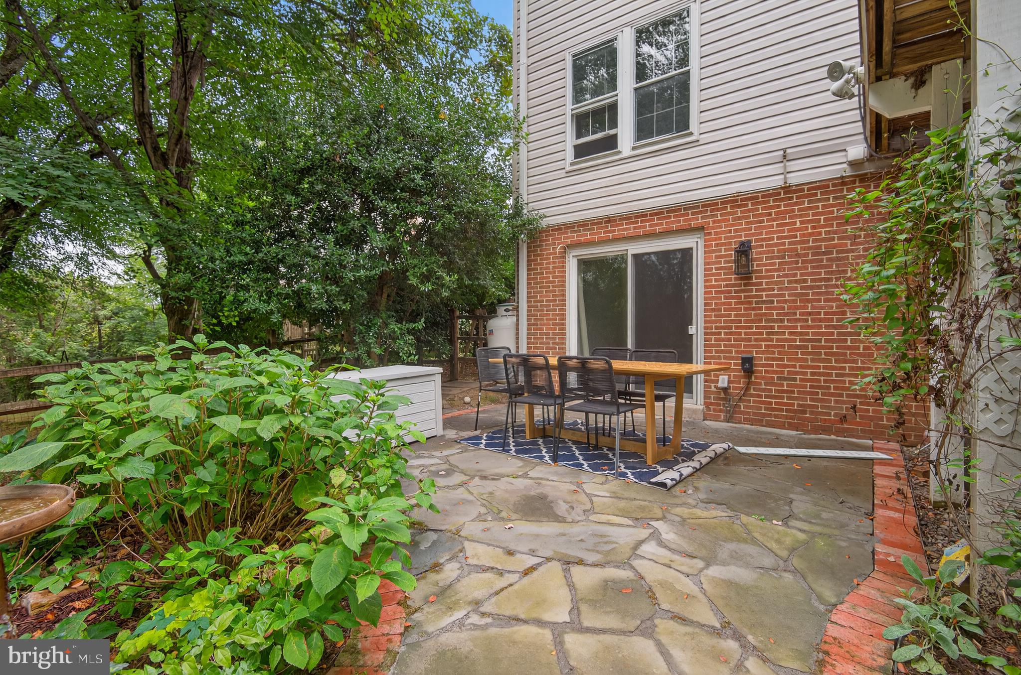 5 Turnham Court Gaithersburg, MD 20878 - Photo 37 of 56 a view of table and chair in backyard of the house