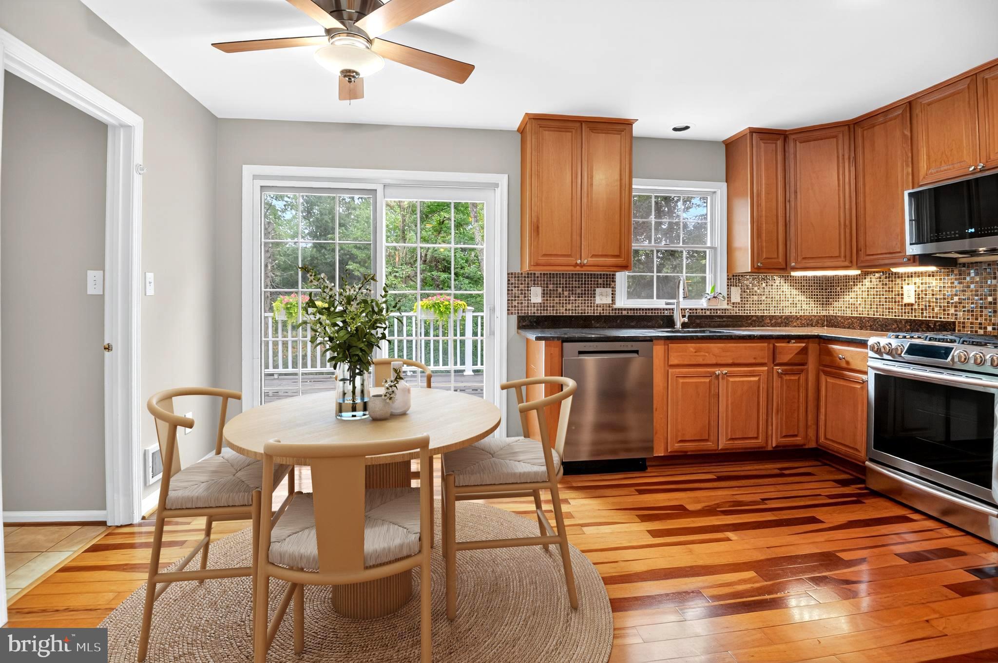 5 Turnham Court Gaithersburg, MD 20878 - Photo 7 of 56 a kitchen with stainless steel appliances granite countertop a stove top oven a sink dishwasher and chairs with wooden floor