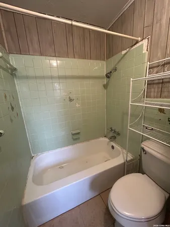 a bathroom with a sink and bathtub with toilet