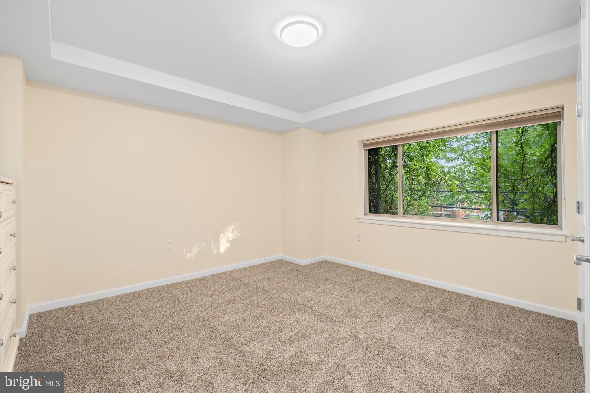 7981 Eastern Avenue Northwest, Unit 219 Silver Spring, MD 20910 - Photo 27 of 45 Primary bedroom with large window
