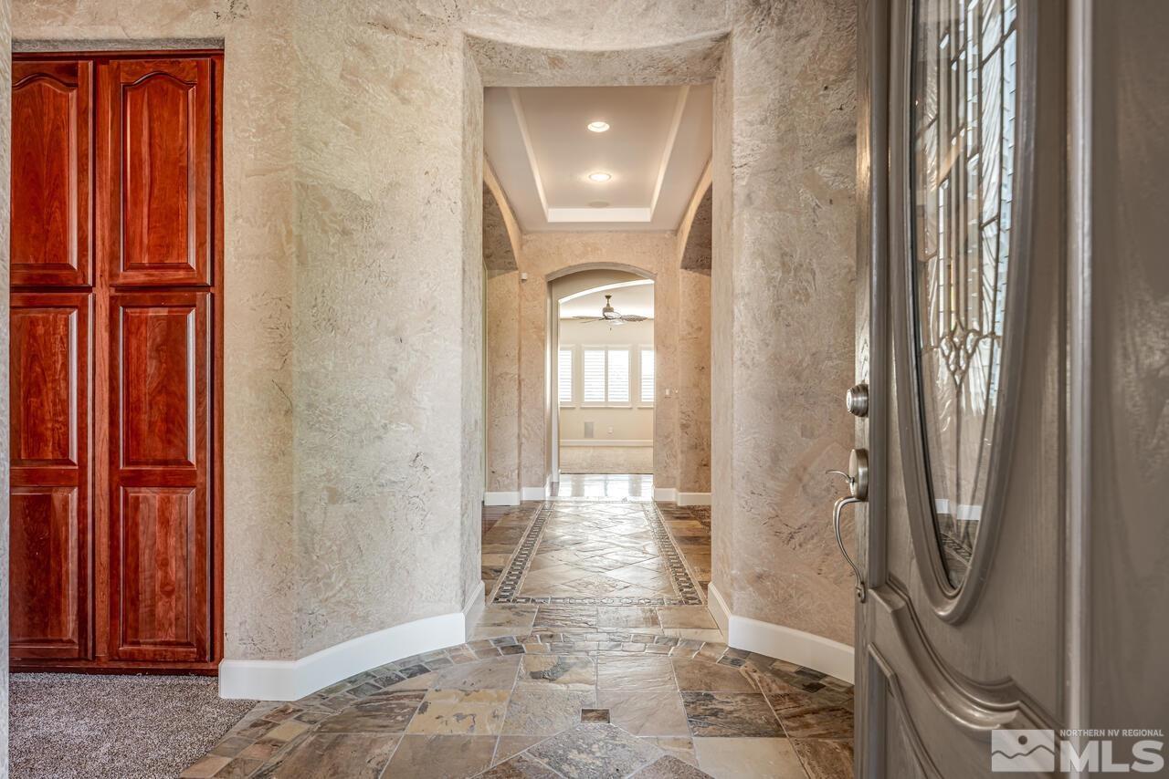 2725 Bull Rider Drive Reno, NV 89521 - Photo 3 of 40 a view of a hallway with wooden floor and a livingroom to rooms