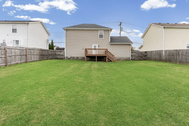 a view of a house with backyard and porch