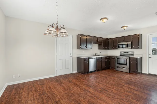 a kitchen with a sink cabinets and stainless steel appliances