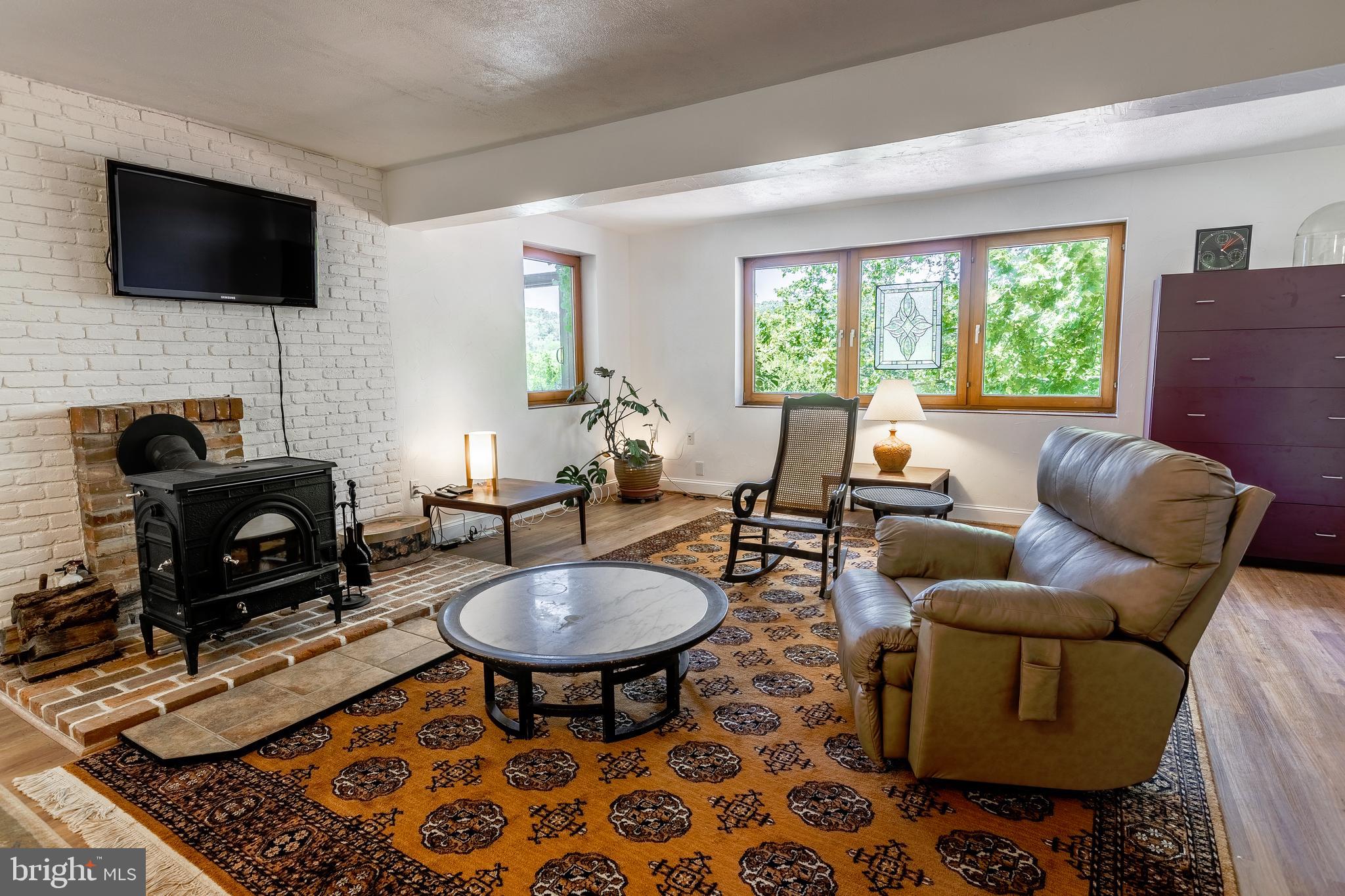 2904 Carrollton Road Finksburg, MD 21048 - Photo 35 of 54 a living room with furniture a fireplace and a flat screen tv