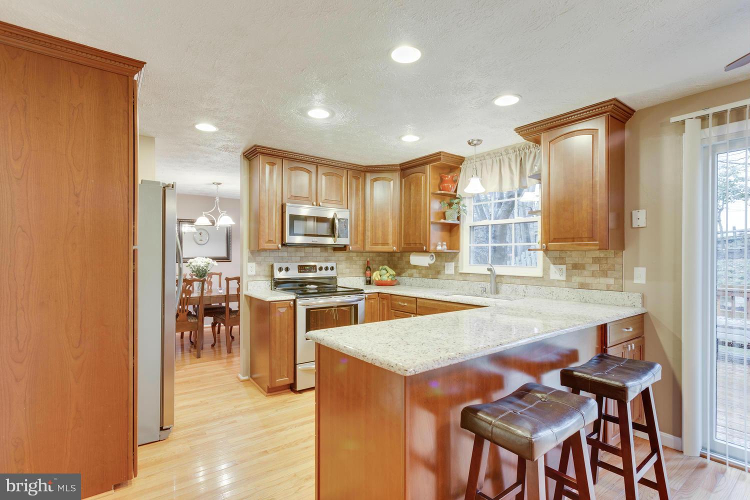 8336 Magic Leaf Road Springfield, VA 22153 - Photo 8 of 30 Kitchen With Breakfast Bar and Many Upgrades