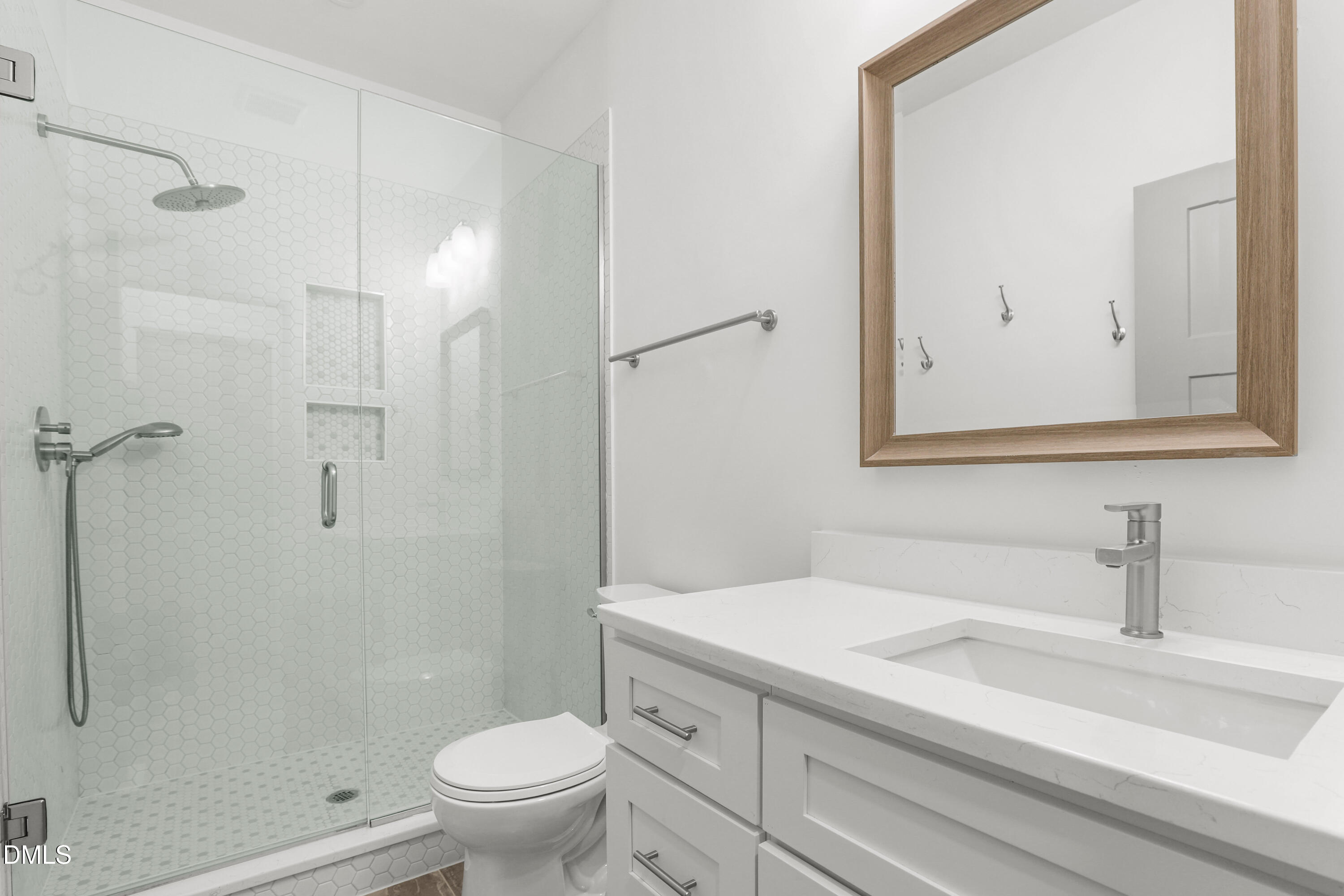 1217 Rosedale Avenue, Unit B Durham, NC 27707 - Photo 11 of 24 a bathroom with a sink a toilet and a mirror