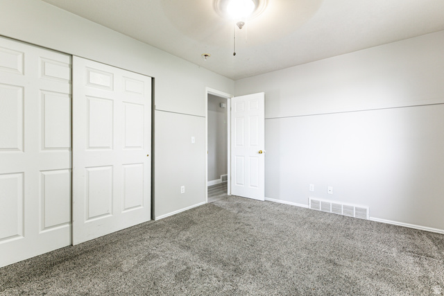 4239 West 5325th Street South Roy, UT 84067 - Photo 15 of 26 Soft gray carpeting complements light gray wall tones, creating a neutral interior