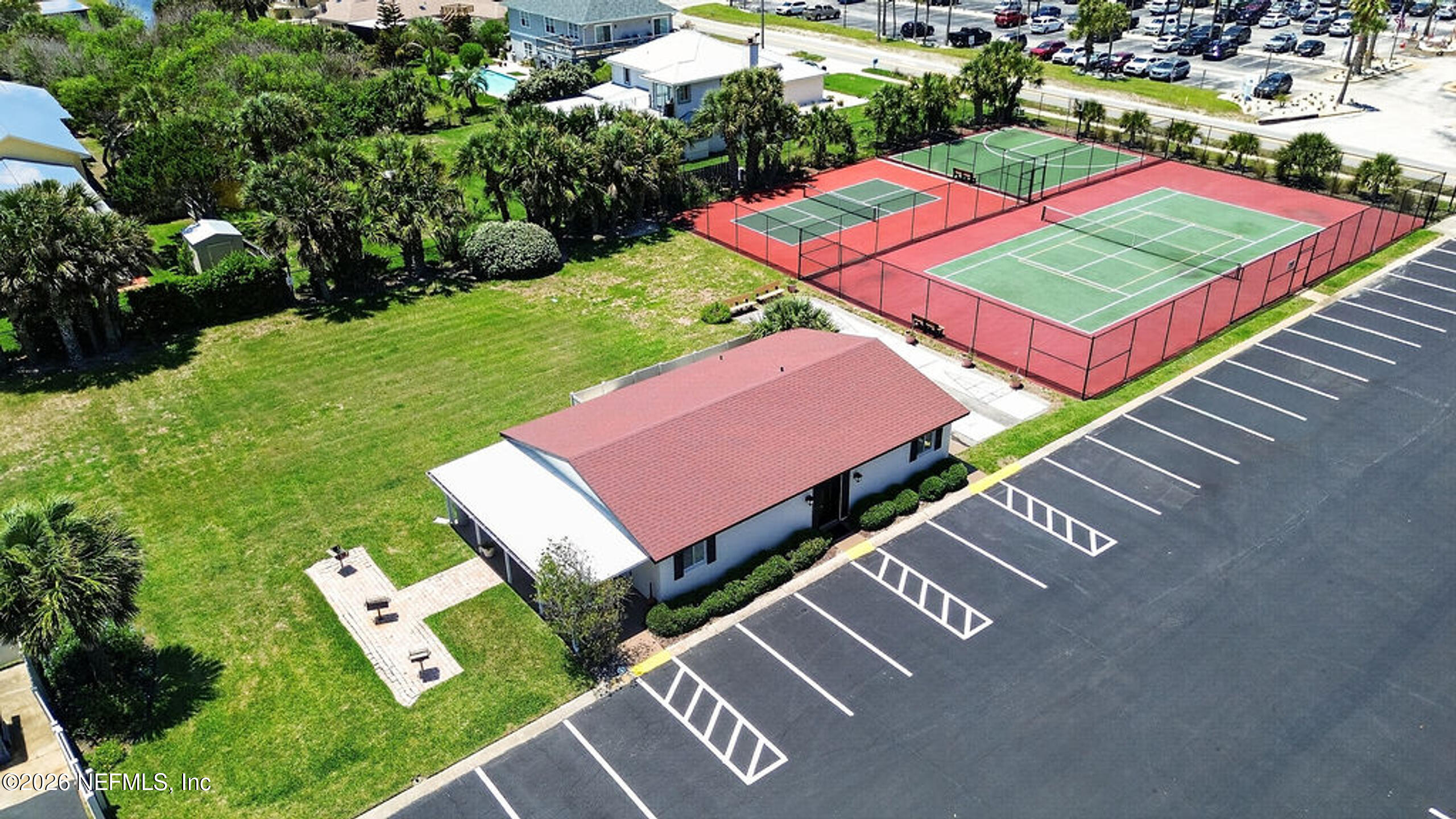 1 Ocean Trace Road, Unit 230 St. Augustine Beach, FL 32080 - Photo 41 of 50 an aerial view of a chairs and table on the green field