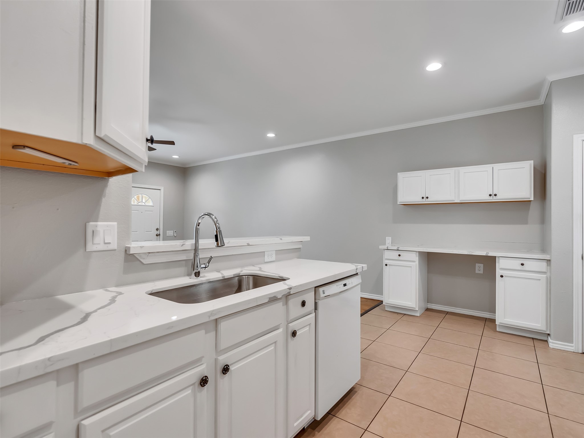 104 Longstreet Road, Unit 2 Willis, TX 77378 - Photo 17 of 26 a kitchen with a sink and cabinets