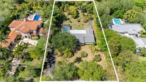 an aerial view of a house with a yard