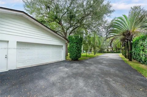 a view of a house with a yard and garage