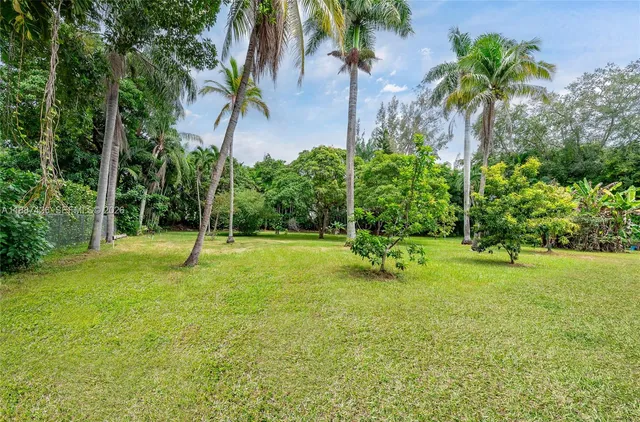 a view of a backyard with swimming pool