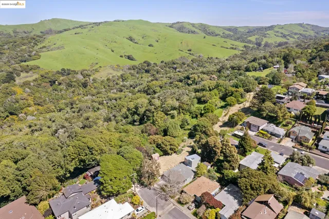 an aerial view of a houses with a yard